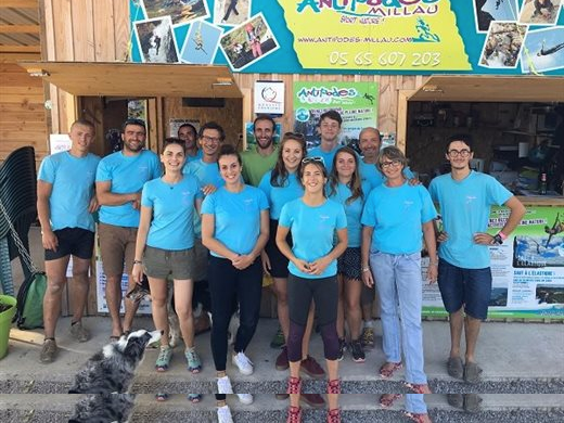 Aurélie Ladet, Frank Aragon et l'équipe d'encadrement d'Antipodes Millau réunis devant leur espace d'accueil outdoor. L'équipe d'Antipodes Millau, spécialiste des sports de nature et d'aventure, posant devant son local d'accueil.
