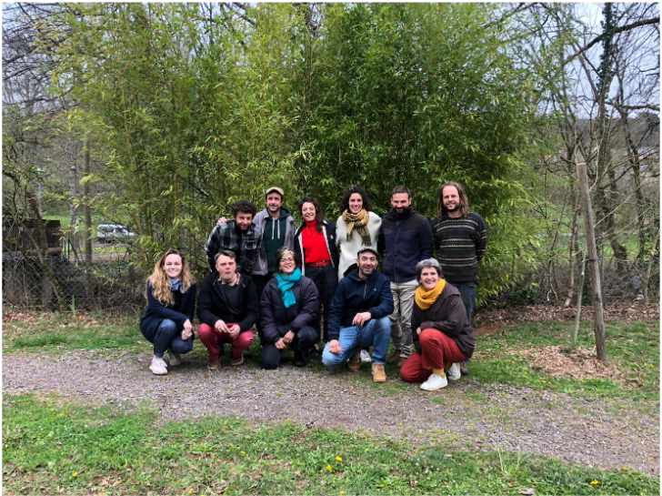 Les membres du collectif « Qu’es acoop » réunis pour construire la future cave coopérative dédiée aux cépages résistants. Photo de groupe des membres du collectif Qu'es acoop posant en extérieur devant des bambous dans le territoire de Conques-Marcillac.